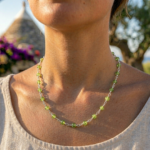 Collanan artigianale Doralie color verde smeraldo con design minimal indossata all’aperto in Puglia